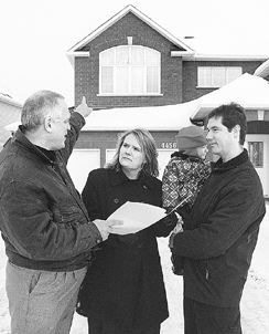 Paul Wilson of HOME INSPECTORS  explains issues to new home owners in Ottawa